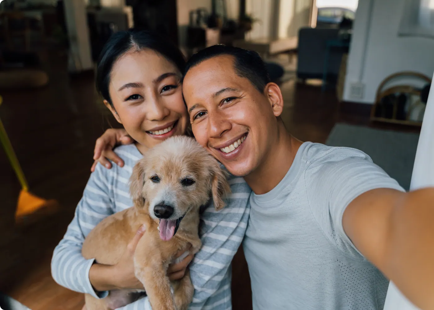 Happy couple relaxing with their dog